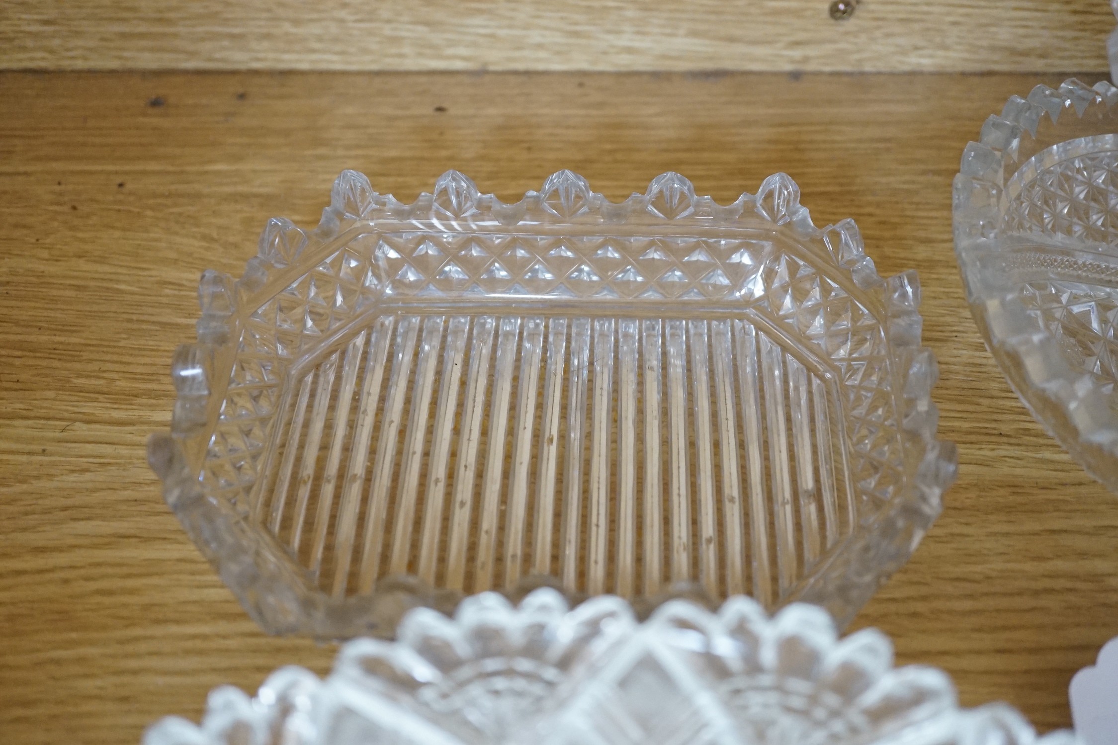 Eight 19th century cut glass circular plates probably Irish, a similar octagonal dish, a later oval cut glass dish and a similar punch bowl, bowl 26 cms diameter